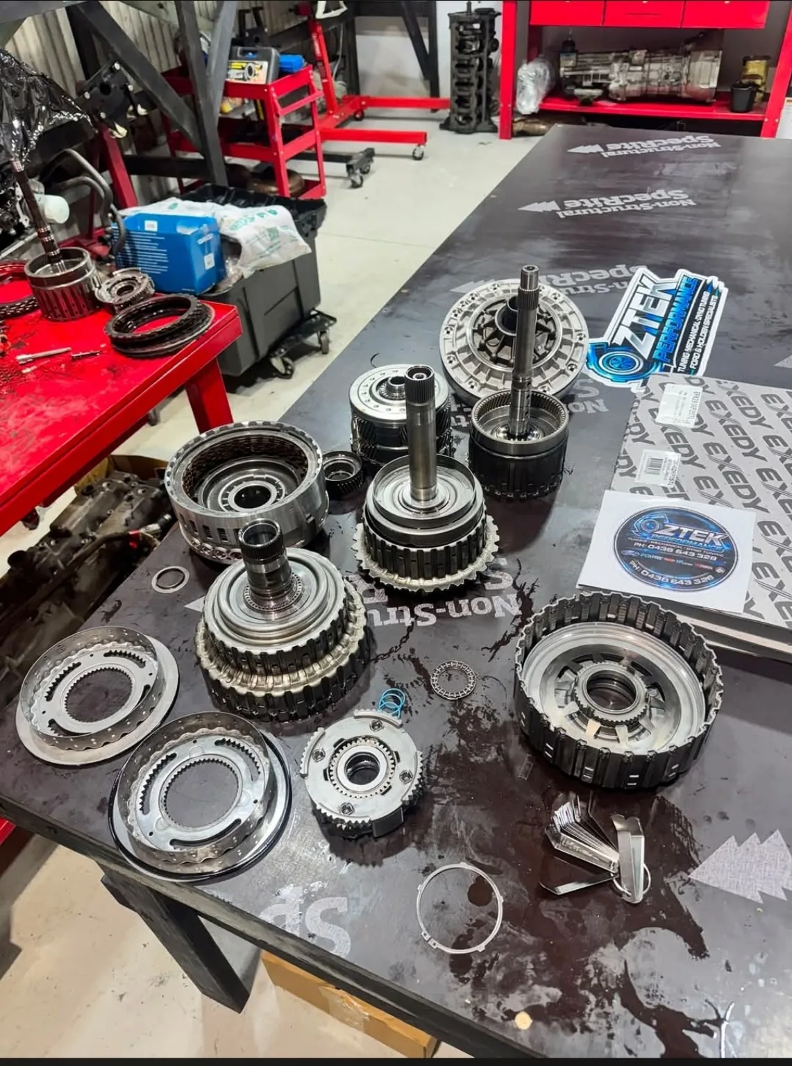 Transmission components on OZTEK workshop bench