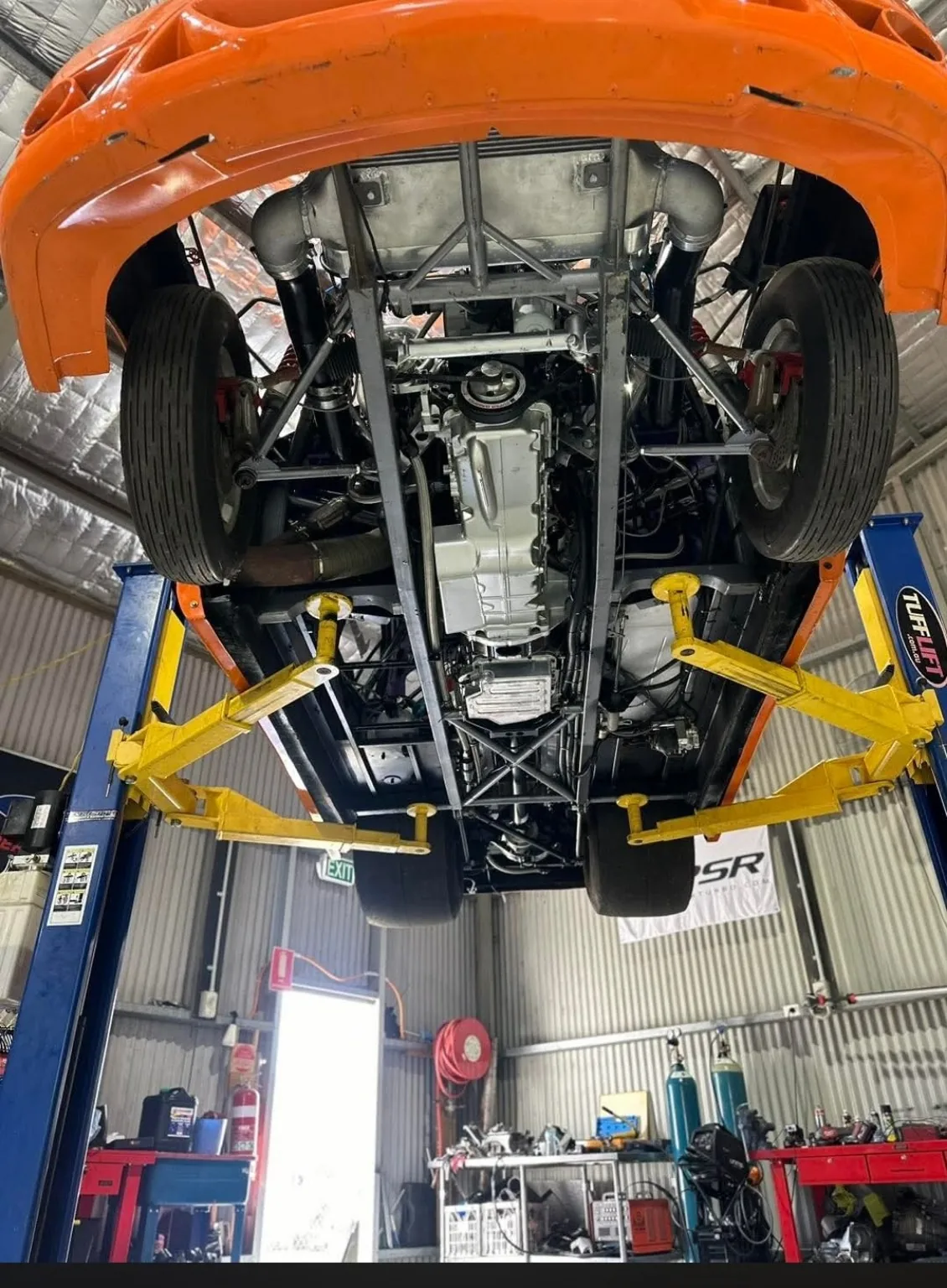 Underside of performance car on hoist