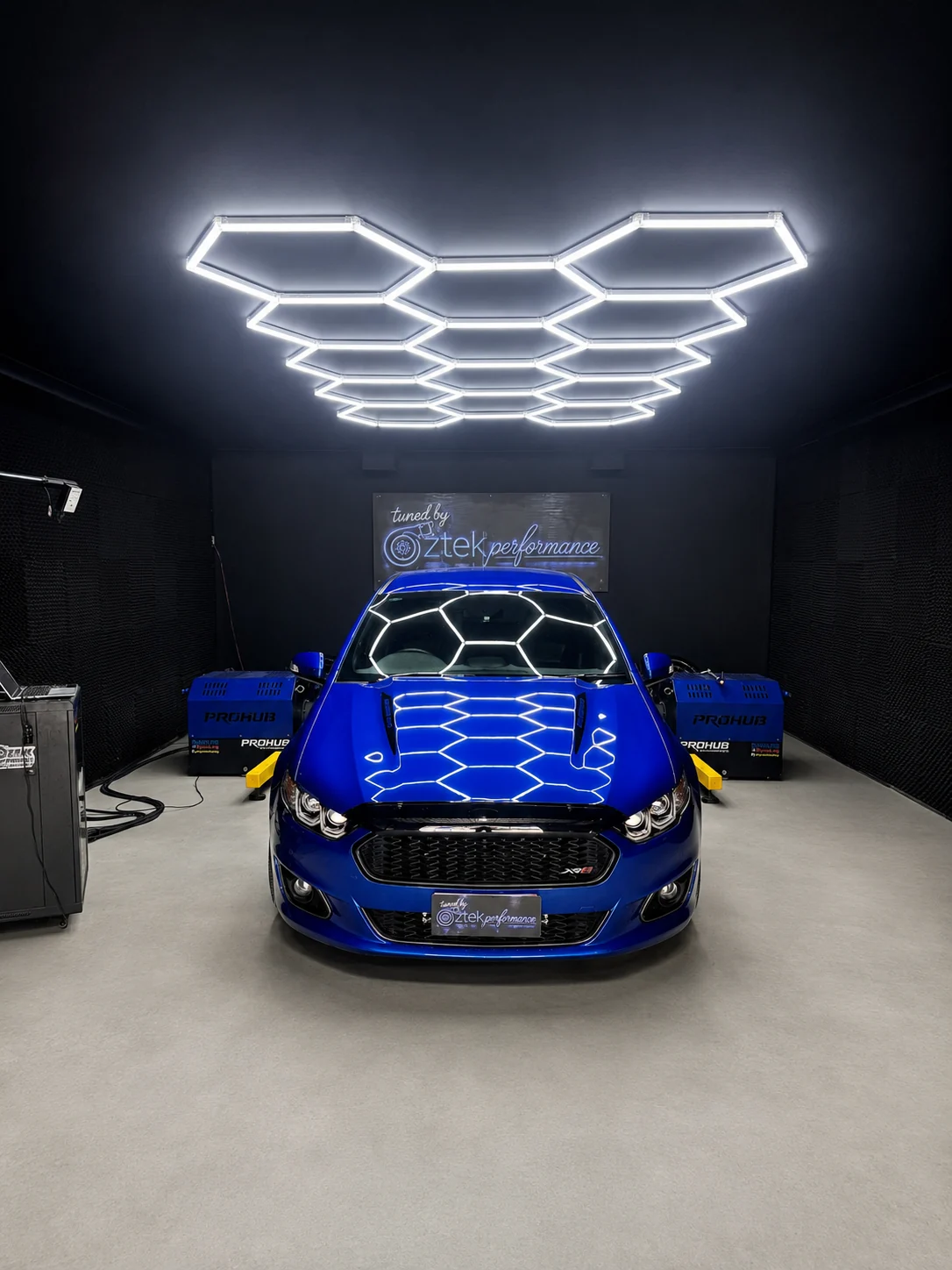 Enhanced blue performance car on hub dyno at OZTEK